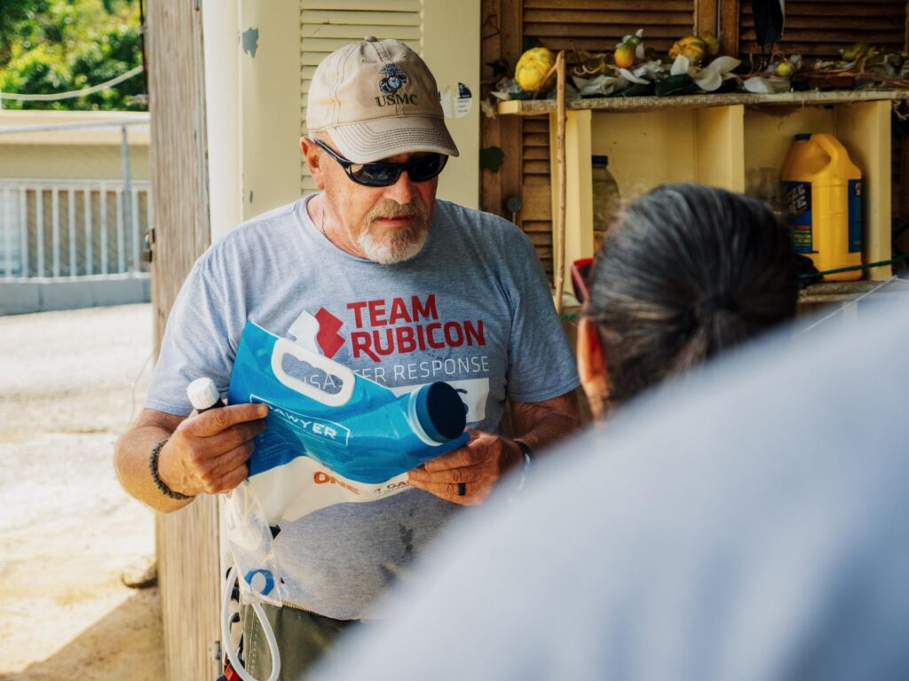 A volunteer holds a Sawyer water filter in Puerto Rico. 