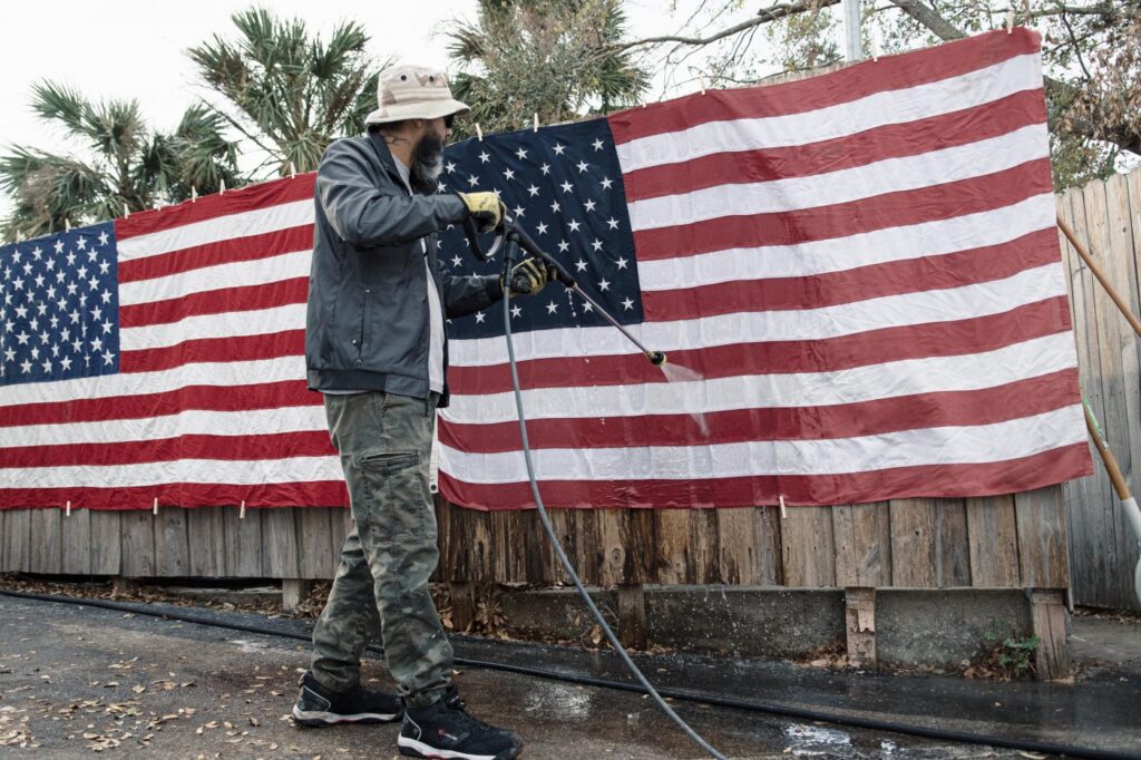 Man washing American Flag.